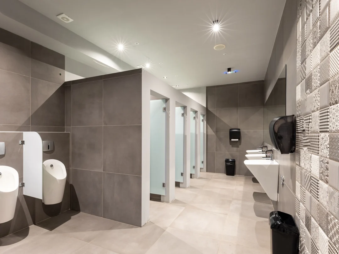 A commercial restroom designed for communal use and convenience.
